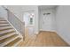 Welcoming home foyer with hardwood floors and staircase, leading into living space at 730 Lanarck Way, Peachtree City, GA 30269