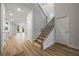 Bright foyer with hardwood floors, staircase, and access to the living spaces at 730 Lanarck Way, Peachtree City, GA 30269