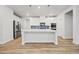 Open kitchen features stainless steel appliances, white cabinetry, and a spacious island with pendant lighting at 730 Lanarck Way, Peachtree City, GA 30269