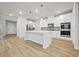 Modern kitchen featuring white cabinets, stainless steel appliances, and a large center island at 730 Lanarck Way, Peachtree City, GA 30269