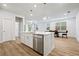 Spacious kitchen island features a stainless steel dishwasher and dining area at 730 Lanarck Way, Peachtree City, GA 30269
