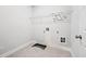 Compact laundry room with neutral walls and floors offers functional space for laundry appliances at 730 Lanarck Way, Peachtree City, GA 30269