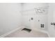 Empty laundry room area with tile floors and metal storage rack at 730 Lanarck Way, Peachtree City, GA 30269
