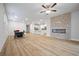 Expansive living area showcasing hardwood floors, modern fireplace, kitchen view, and elegant dining space at 730 Lanarck Way, Peachtree City, GA 30269