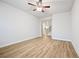 Bright living room with hardwood floors featuring a ceiling fan and natural light from the windows at 730 Lanarck Way, Peachtree City, GA 30269