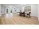 Open-concept living room with hardwood floors, lots of windows, and adjacent dining area at 730 Lanarck Way, Peachtree City, GA 30269