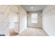 Walk-in closet featuring carpeted floors, built-in wire shelving, and a window at 748 Great Oak Pl, Villa Rica, GA 30180