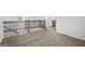 Hallway featuring neutral carpet and wood and iron railings, leading to bedrooms and bathrooms at 748 Great Oak Pl, Villa Rica, GA 30180