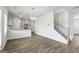 Living room showcasing LVP flooring and a view of kitchen and staircase enhancing the open floorplan at 748 Great Oak Pl, Villa Rica, GA 30180