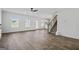 Sunlit living room with LVP flooring, ceiling fan and view of backyard through three windows at 748 Great Oak Pl, Villa Rica, GA 30180