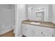 Bathroom features a tub and shower, a vanity with storage and a large mirror at 1111 Louise Se Ct, Conyers, GA 30013