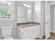 A clean bathroom features white fixtures and a large window at 1111 Louise Se Ct, Conyers, GA 30013