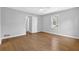 Spacious bedroom with light gray walls, a ceiling fan, hardwood floors and a bright window at 1111 Louise Se Ct, Conyers, GA 30013
