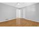 A bedroom with neutral walls, wood floors, ceiling fan and an ensuite bathroom at 1111 Louise Se Ct, Conyers, GA 30013