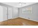 Neutral bedroom features laminate wood flooring, natural light, and a ceiling fan at 1111 Louise Se Ct, Conyers, GA 30013