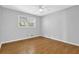Bright bedroom featuring laminate flooring and a window view at 1111 Louise Se Ct, Conyers, GA 30013