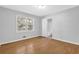 Bright bedroom features wood floors, natural light and neutral wall paint at 1111 Louise Se Ct, Conyers, GA 30013