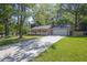 Charming single-story home with a well-manicured front yard, a long driveway and an attached two-car garage at 1111 Louise Se Ct, Conyers, GA 30013