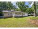 Exterior view of cozy home with green lawn and tree-lined surroundings at 1111 Louise Se Ct, Conyers, GA 30013