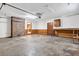 Spacious garage with brick accent, wood paneling, and workbench with room for storage at 1111 Louise Se Ct, Conyers, GA 30013