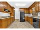 Well-equipped kitchen with wooden cabinets, sleek black appliances, and ample counter space at 1111 Louise Se Ct, Conyers, GA 30013
