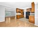 Open-concept kitchen features wood cabinets, black appliances, and view to a living area at 1111 Louise Se Ct, Conyers, GA 30013