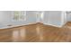 Open living room with new hardwood floors, neutral paint, and plenty of natural light at 1111 Louise Se Ct, Conyers, GA 30013