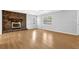 Bright living room featuring a brick fireplace, laminate flooring, and ample natural light at 1111 Louise Se Ct, Conyers, GA 30013