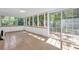 Bright sunroom with tile flooring, large windows and sliding door to deck, offering an inviting and light-filled space at 1111 Louise Se Ct, Conyers, GA 30013