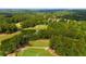 Breathtaking aerial view of a lush golf course, serene lakes, and well-manicured landscaping at 4216 Tattnall Run, Acworth, GA 30101