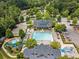 Beautiful aerial view of the community pool, slides and clubhouse nestled in a wooded setting at 4216 Tattnall Run, Acworth, GA 30101