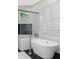 Spa bathroom features a modern soaking tub with black and white accents at 4216 Tattnall Run, Acworth, GA 30101