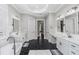 Luxurious bathroom featuring dual vanities, hexagon tile flooring and a soaking tub at 4216 Tattnall Run, Acworth, GA 30101