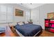 Cozy bedroom featuring a comfortable bed, stylish shutters, and hardwood floors at 4216 Tattnall Run, Acworth, GA 30101