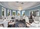 Dining room with a chandelier, light blue walls, and large windows with greenery outside at 4216 Tattnall Run, Acworth, GA 30101
