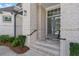 Elegant home entrance with light brick, gray doors, and well-maintained landscaping at 4216 Tattnall Run, Acworth, GA 30101