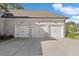 Exterior view of the home showcasing the three-car garage and concrete driveway at 4216 Tattnall Run, Acworth, GA 30101
