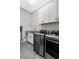 Well-organized laundry room with modern appliances, granite countertop and ample cabinet space at 4216 Tattnall Run, Acworth, GA 30101