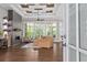 Spacious living room with fireplace, coffered ceiling, hardwood floors, and large windows at 4216 Tattnall Run, Acworth, GA 30101