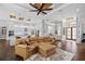 Living room with hardwood flooring, a leather couch, fireplace, and view of the kitchen at 4216 Tattnall Run, Acworth, GA 30101