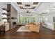 Bright open living room featuring a stone fireplace, coffered ceilings, and hardwood floors at 4216 Tattnall Run, Acworth, GA 30101