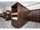 Men's locker room with dark wood lockers and a geometric patterned floor at 4216 Tattnall Run, Acworth, GA 30101