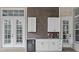 This outdoor kitchen features white cabinets and stainless steel appliances at 4216 Tattnall Run, Acworth, GA 30101