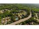 Aerial view of a neighborhood surrounded by lush trees, a community pool and tennis courts at 5015 Preservation Pointe Nw, Kennesaw, GA 30152