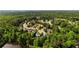 An aerial view shows a neighborhood with mature trees and landscaping at 5015 Preservation Pointe Nw, Kennesaw, GA 30152