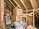 Well-lit attic storage space with exposed rafters, insulation, and ample room for storage at 5015 Preservation Pointe Nw, Kennesaw, GA 30152