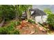 Aerial view of a house with a backyard featuring a play set, lush greenery, mature trees, and an outdoor seating area at 5015 Preservation Pointe Nw, Kennesaw, GA 30152