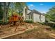 Spacious backyard featuring a wooden playset and swing for outdoor fun in a lush, green setting at 5015 Preservation Pointe Nw, Kennesaw, GA 30152