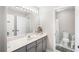 Bathroom featuring a white vanity with a large mirror and shower-tub combination in a separate room at 5015 Preservation Pointe Nw, Kennesaw, GA 30152