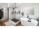 Bright bathroom featuring a glass enclosed shower, a modern soaking tub and wood look tile floors at 5015 Preservation Pointe Nw, Kennesaw, GA 30152